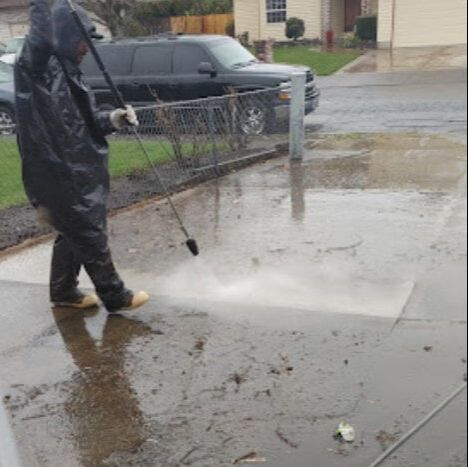  Rip City Roof Cleaning  worker doing driveway pressure washing service